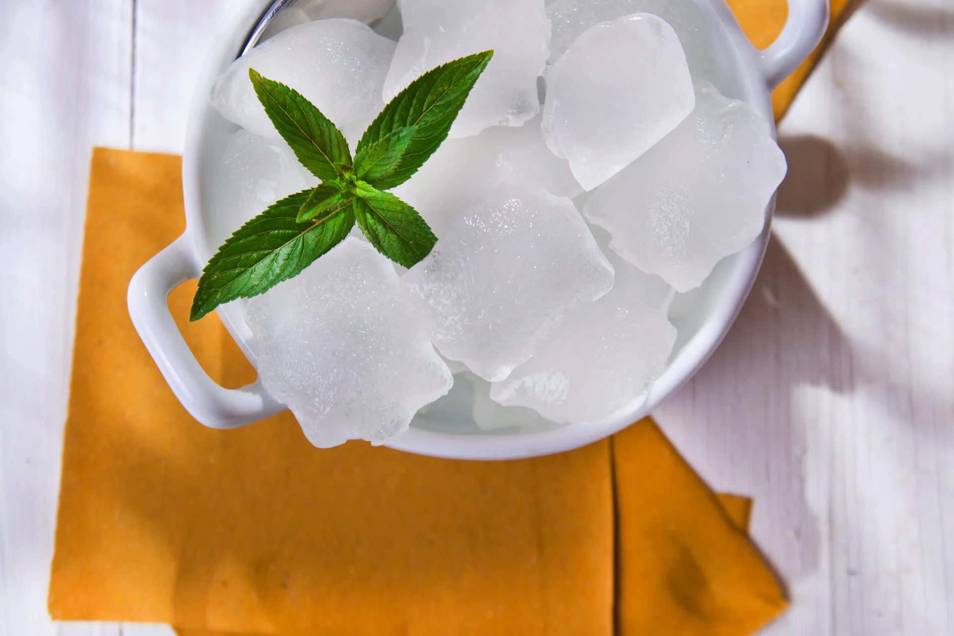 ice cubes and mint in a cup