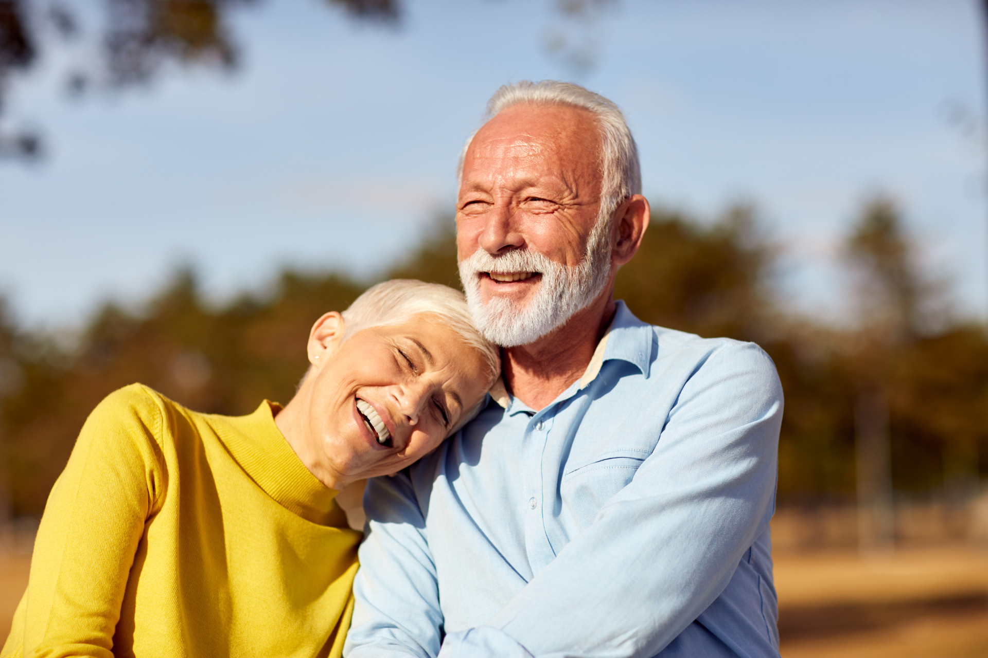 older couple smiling in the sunshine