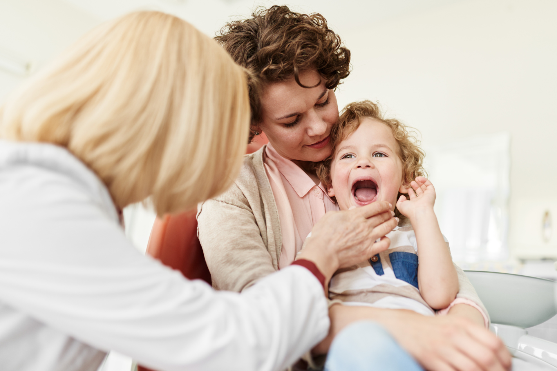pediatric dental exam adorable baby with a yellow bear